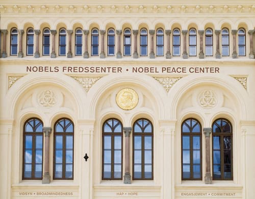 Gevel van het Nobel Vredescentrum in Olso, Noorwegen met het opschrift: Nobels Fredssenter