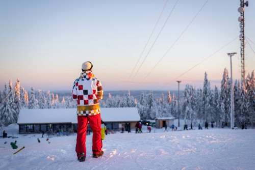 Snowboarders op een besneeuwde skipiste in het avondlicht